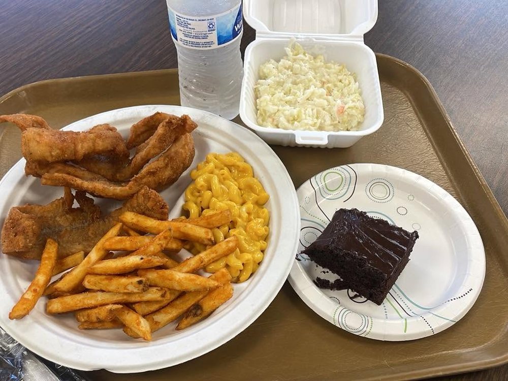 A fish fry dinner: hand-breaded pollack, fries, macaroni, coleslaw and chocolate cake