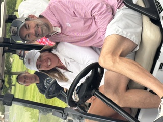 Players heading out to the course in the carts